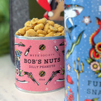 Can of 'Bob's Nuts Dilly Peanuts' with colorful label with Furikake Snack Mix in foreground
