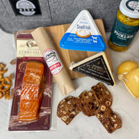 Care Package comes with cheese, smoked salmon, salami, artisan crackers, pickled fennel, and mustard to make a lovely grazing board.