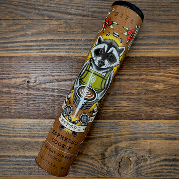 Espresso Cookie Tin with raccoon illustration on a wooden surface