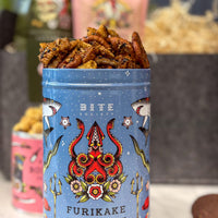 Furikake snack in a blue container with decorative design, featuring the brand 'Bite Society'.