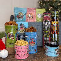 Snacks for the Sleigh Holiday Gift Basket with tins of snacks, cocoa, and cookies.