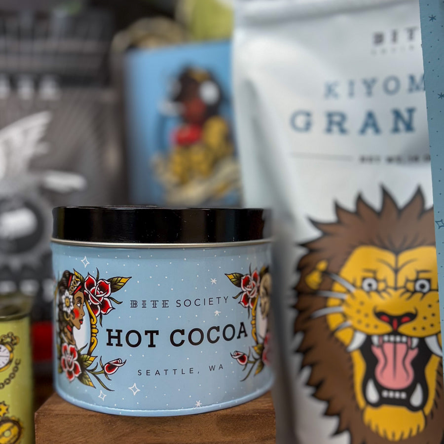 Bite Society Hot Cocoa container with colorful packaging featuring a lion and text.
