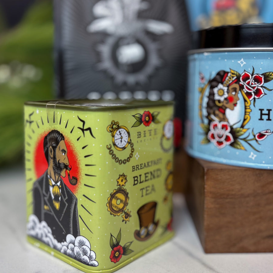 Tea canister with decorative design featuring a man with a pipe and text 'Breakfast Blend Tea'.