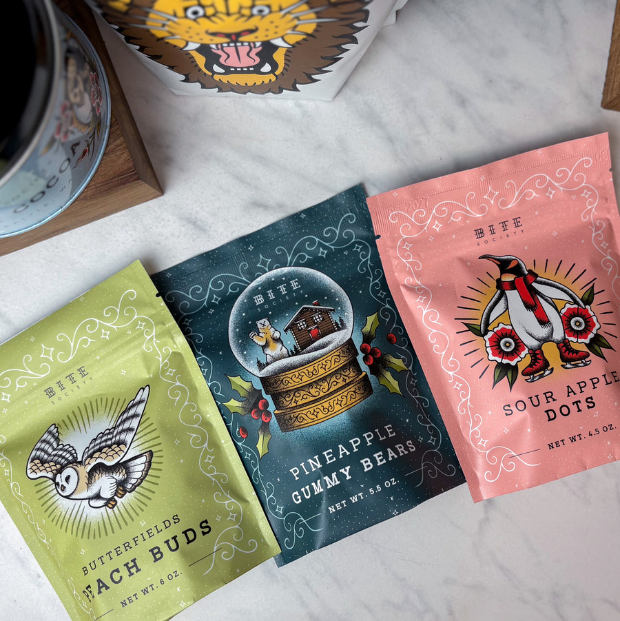 Three colorful candy packages on a marble surface