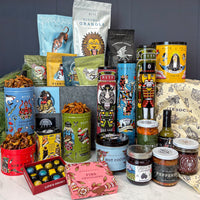 Jingle Belly Gift Basket Packs it in. Large basket of Christmas Goodies in decorative tins, bags, jars, and boxes