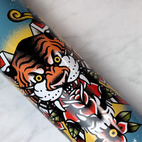 Colorful tattoo-style design of a tiger on a cookie tin with a white background