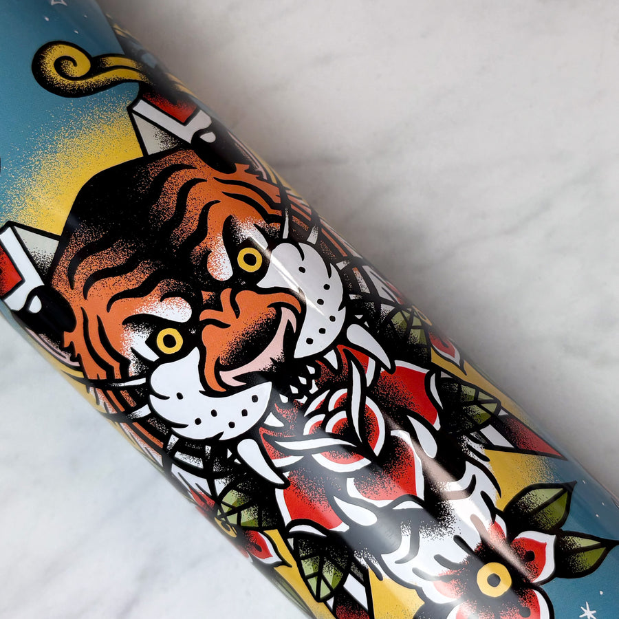 Colorful tattoo-style design of a tiger on a cookie tin with a white background