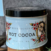 Bite Society hot cocoa tin with decorative label featuring a skull and roses.