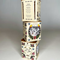 A stack of Bite Society Tulsi Spice Tea Tins showing three sides of this tattoo themed tea tin. 