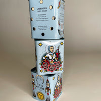 This leaning tower of Bite Society Lavender Earl Grey Tea Tins shows three sides of this tattoo themed tea tin. 
